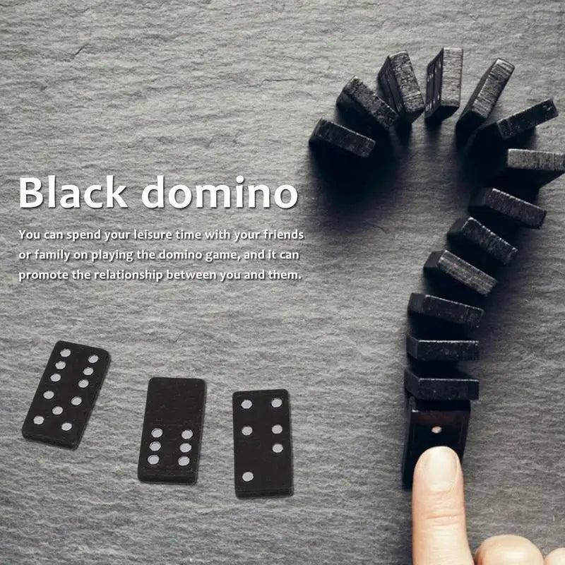 Black dominoes on a gray surface with text about playing dominoes.