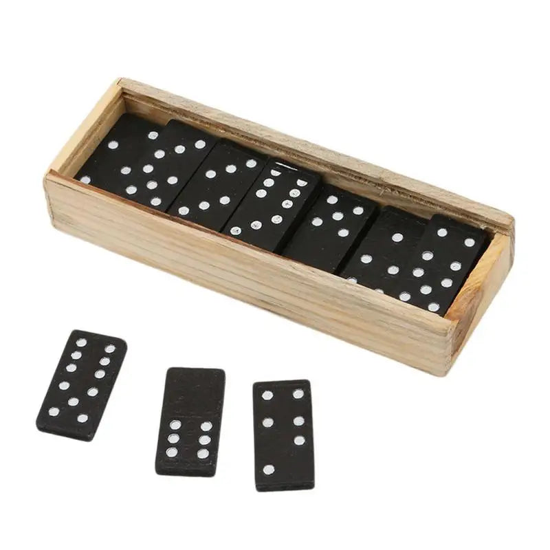 A set of black domino pieces with white dots, displayed in a wooden storage box.