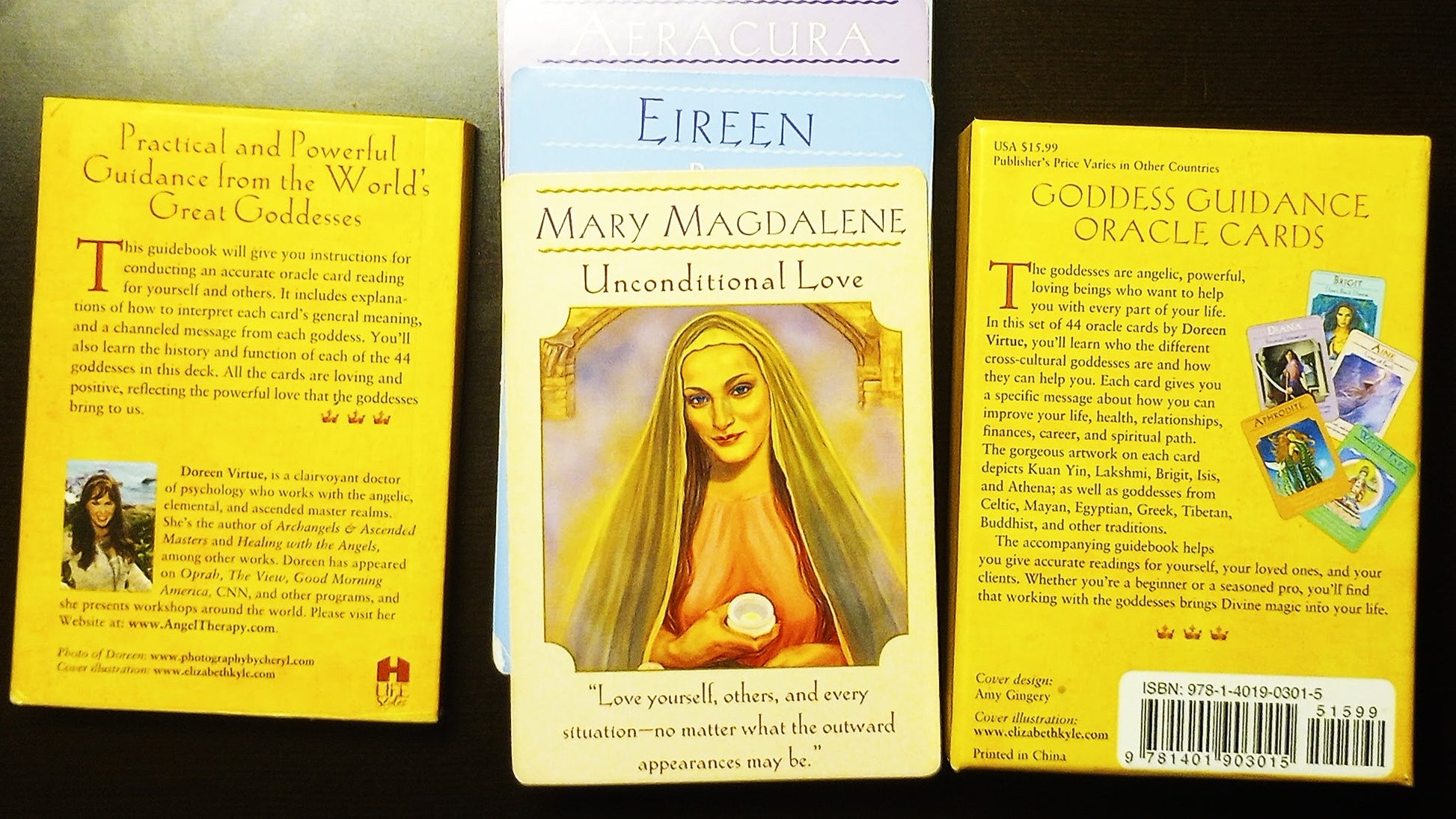 Back cover of Oracle card box and guidebook with images of various Tarot/Oracle cards and text on a dark background