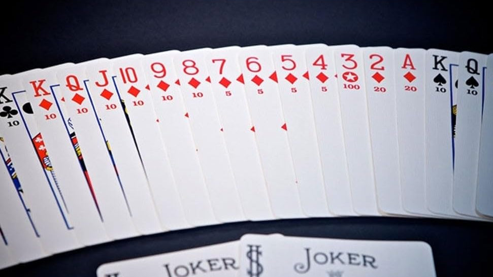 Fanned-out deck of playing cards with jokers on a dark background