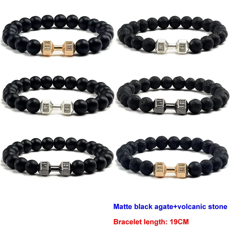 Set of six matte black agate and volcanic stone bracelets with metal beads on a white background.