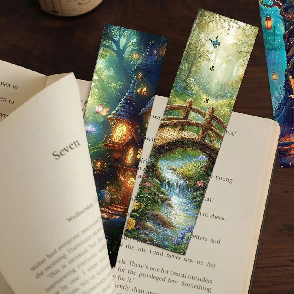 Three colorful bookmarks with fairy tale designs on an open book.