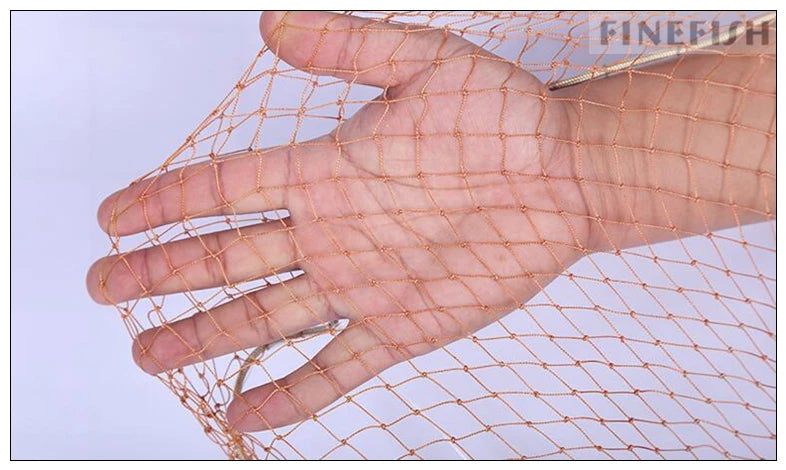 Fishing net being displayed close-up with hand holding mesh out for view of extended net design