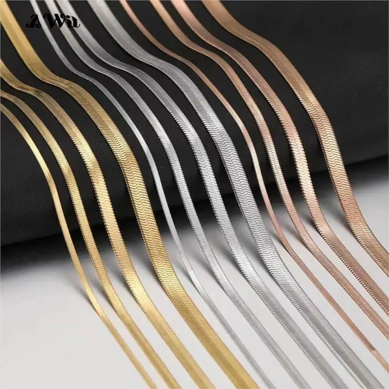 Close-up of gold and silver flat chains over a dark background