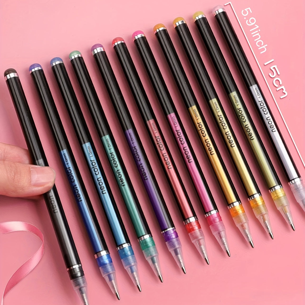 Set of colorful pens with gradient caps on a pink background