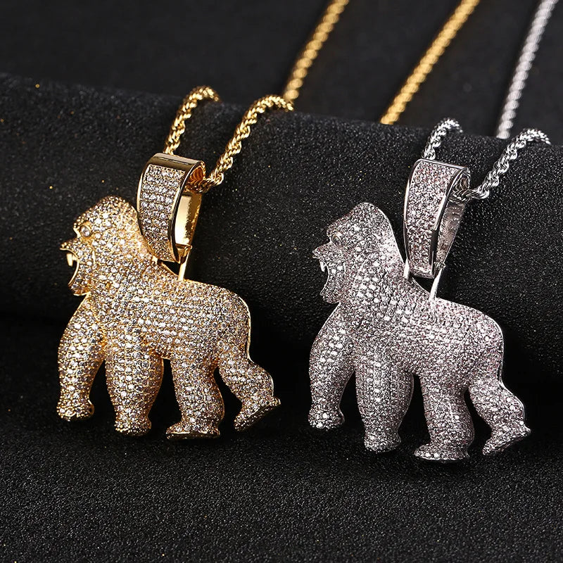 Gold and silver gorilla pendants on chains against a black background
