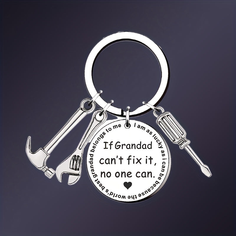 Keychain with tool charms and engraved message on a dark background