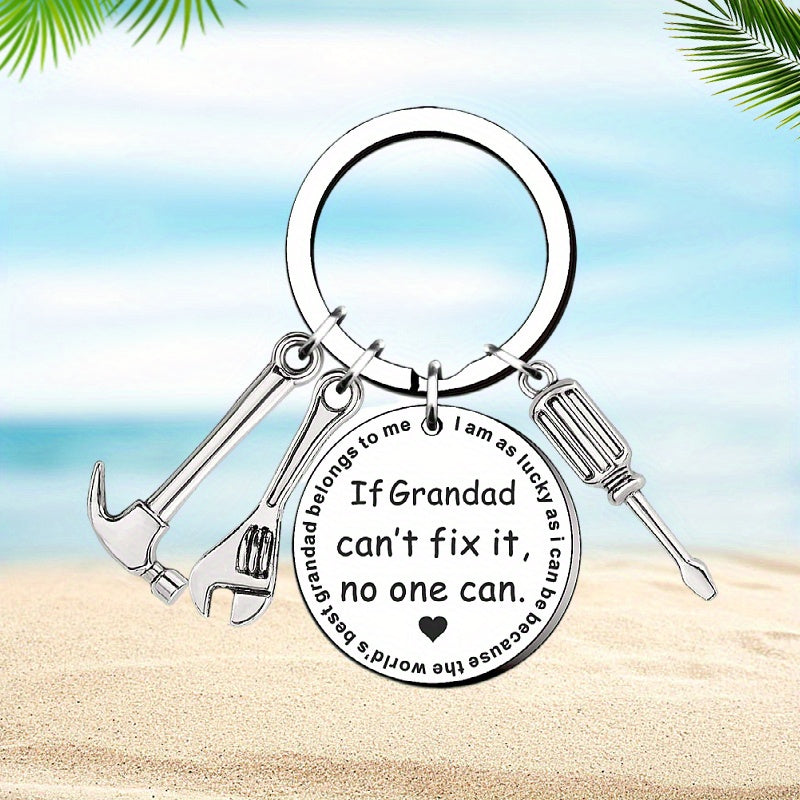 Keychain with tools and engraved text on a beach background