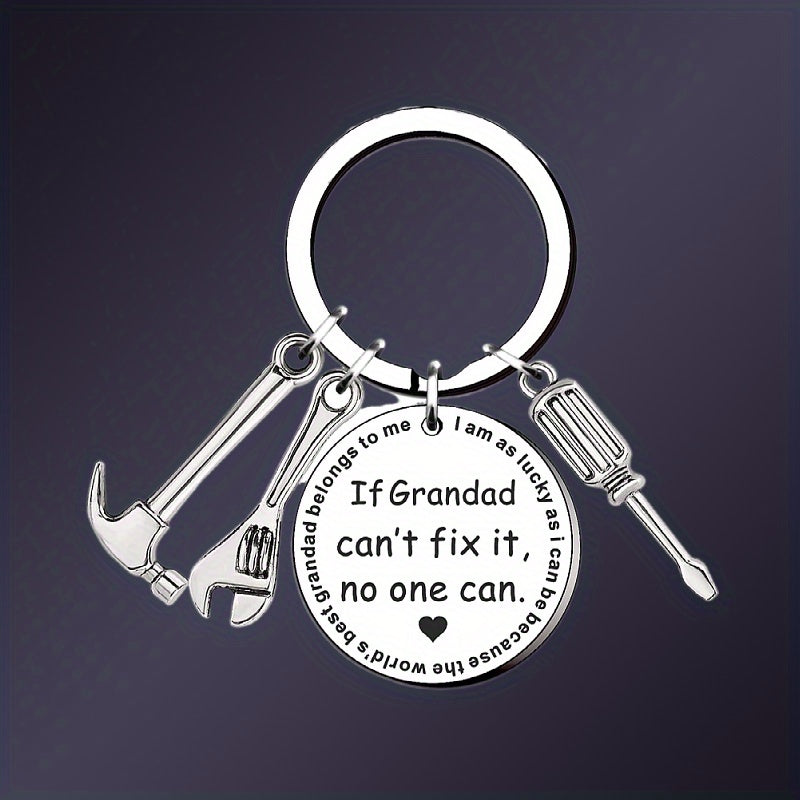 Keychain with tool charms and engraved message on a dark background