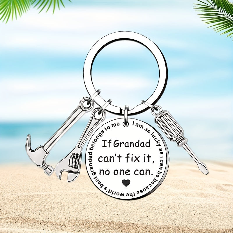 Keychain with tools and engraved text on a beach background