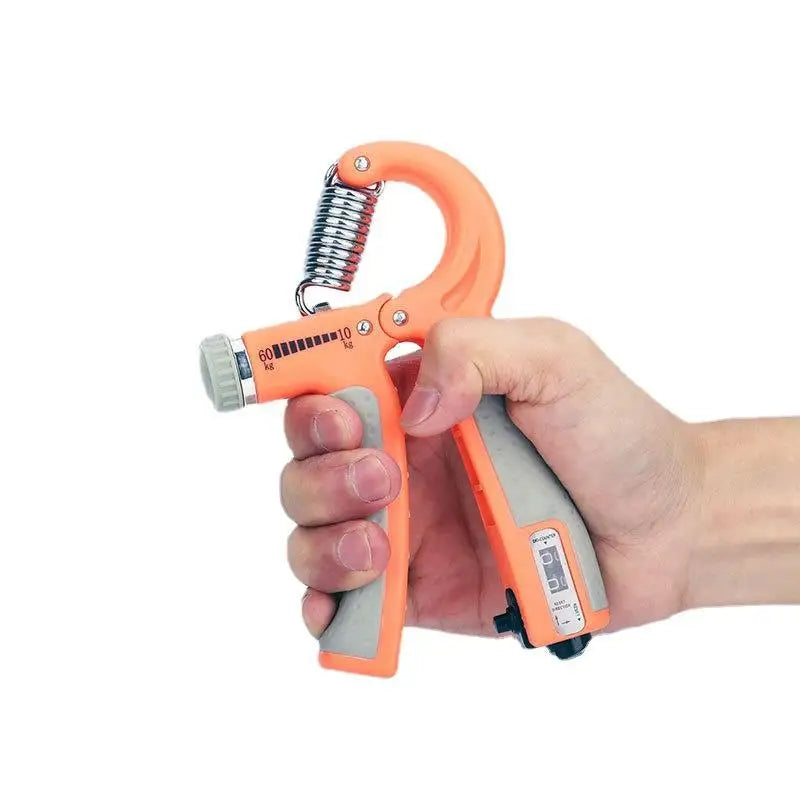 Hand holding an orange and gray hand gripper against a white background