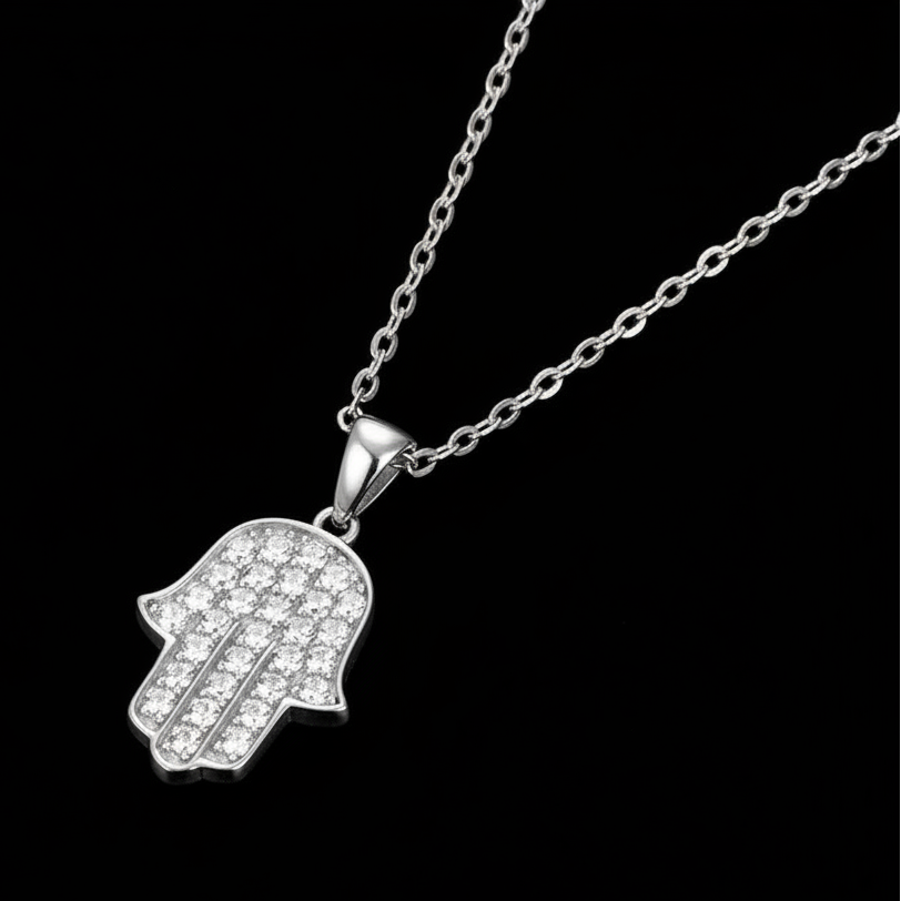 Silver Hamsa hand Fatima pendant necklace on a black background