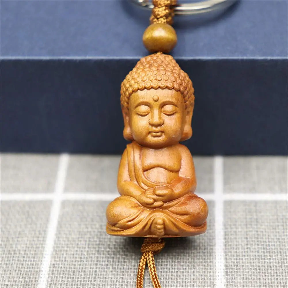 Hand-carved wooden Buddha keychains with prayer and meditation poses