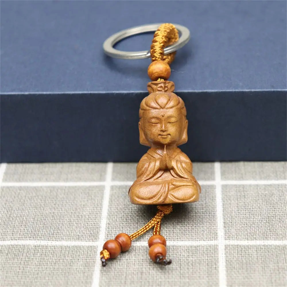Hand-carved wooden Buddha keychains with prayer and meditation poses