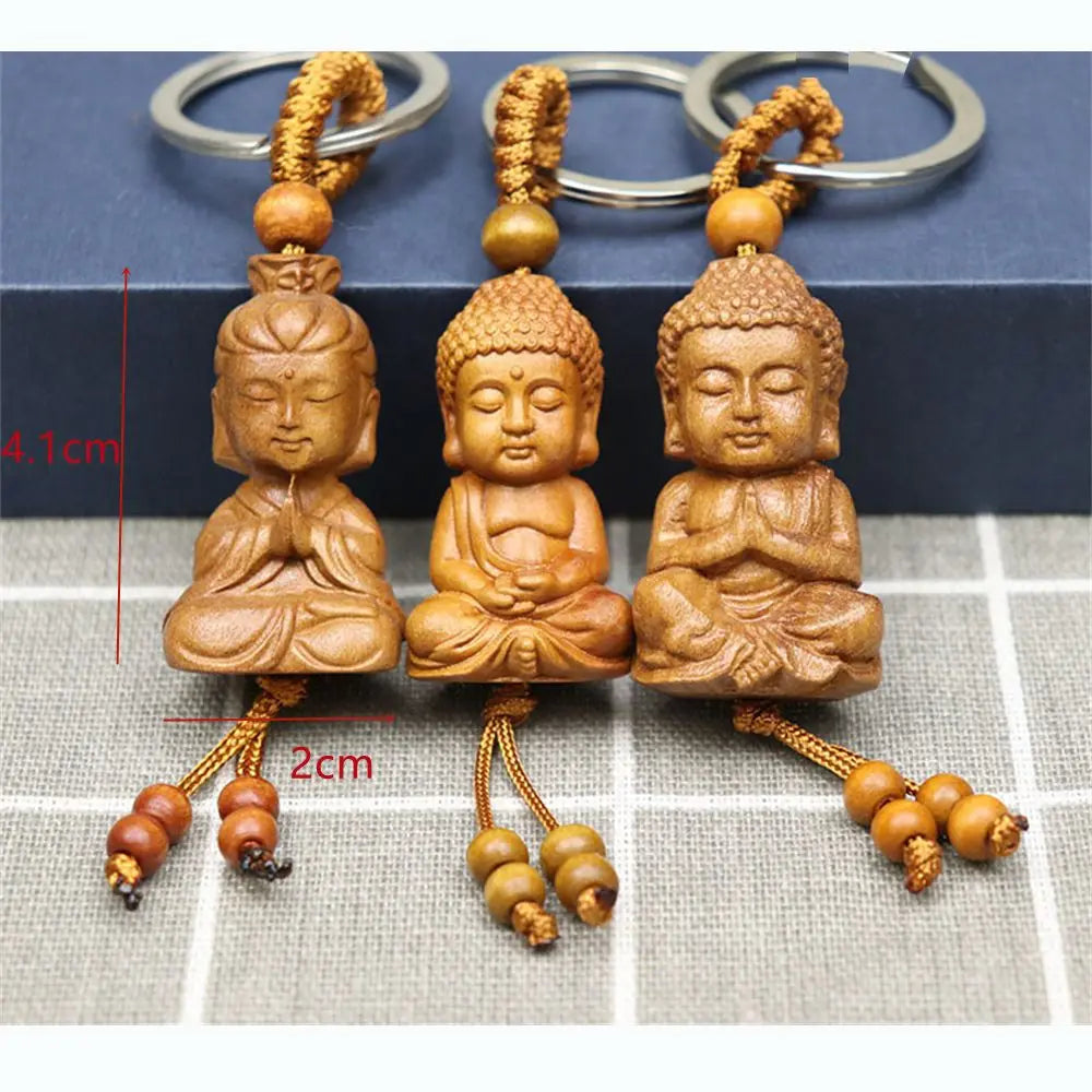 Hand-carved wooden Buddha keychains with prayer and meditation poses