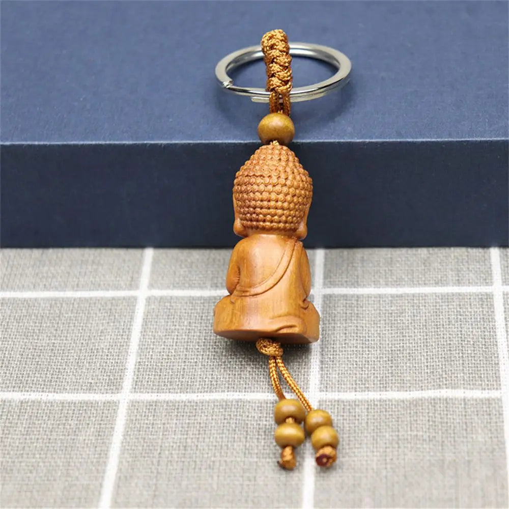 Hand-carved wooden Buddha keychains with prayer and meditation poses