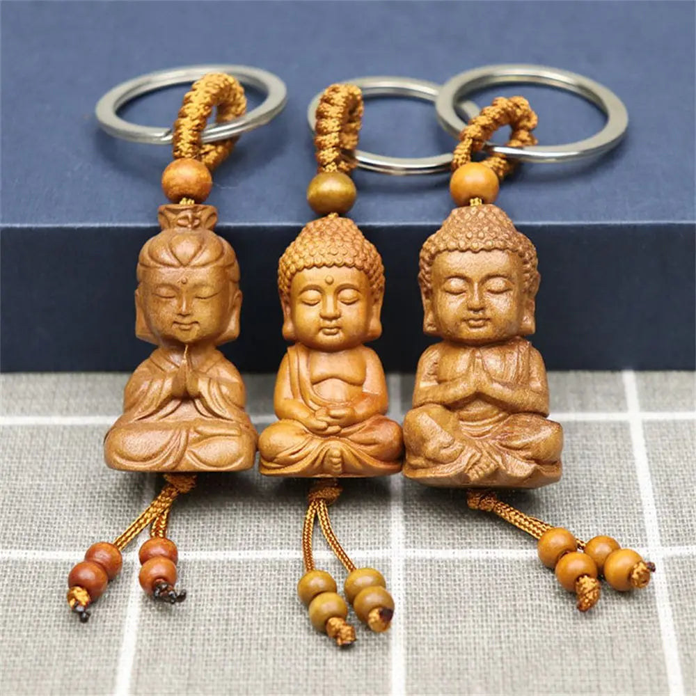 Hand-carved wooden Buddha keychains with prayer and meditation poses