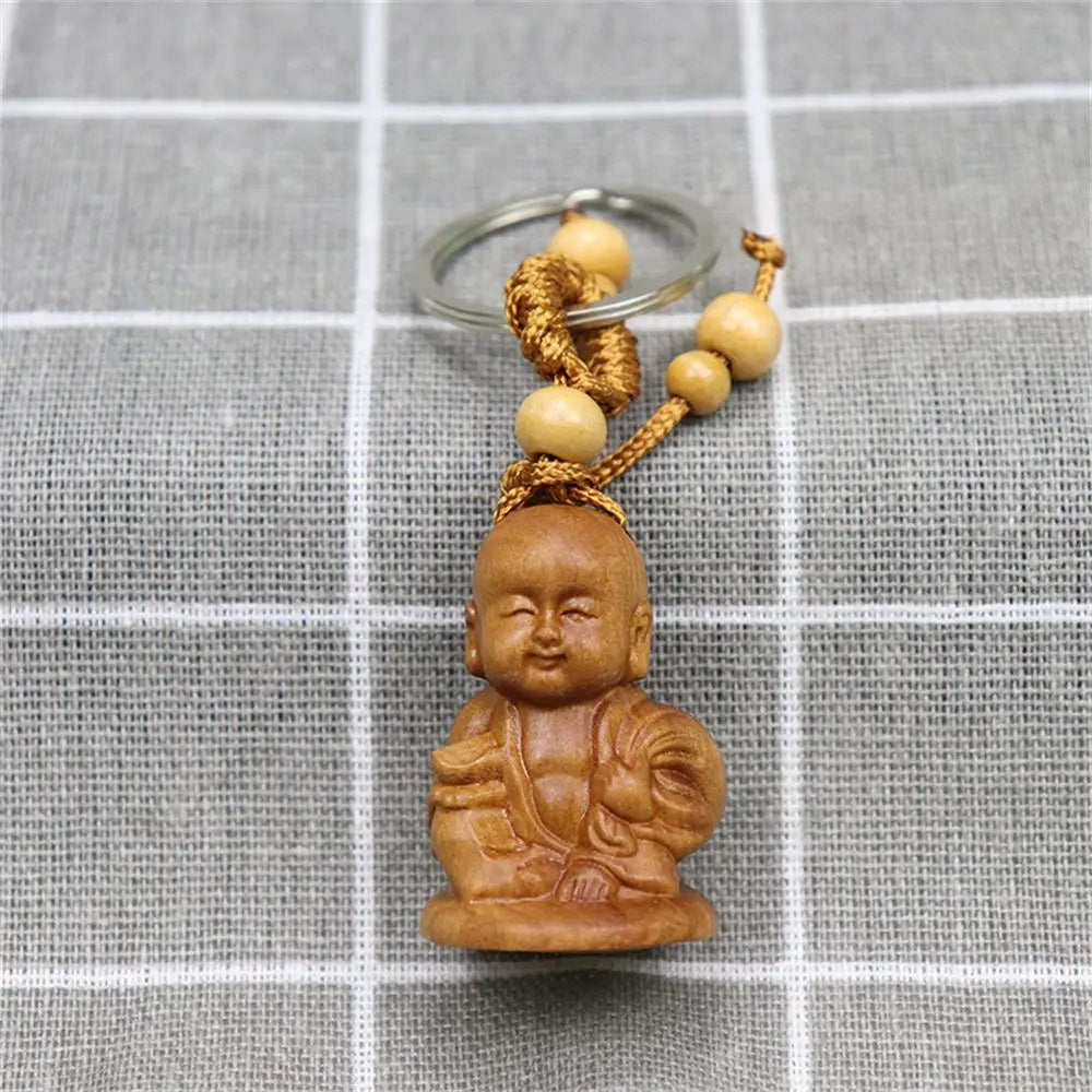 Hand-carved wooden Buddha keychains with prayer and meditation poses