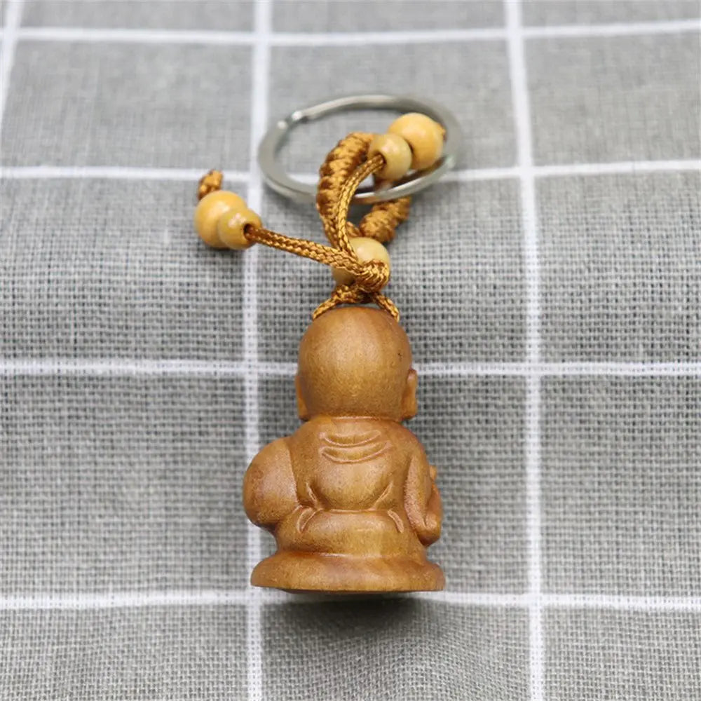 Hand-carved wooden Buddha keychains with prayer and meditation poses