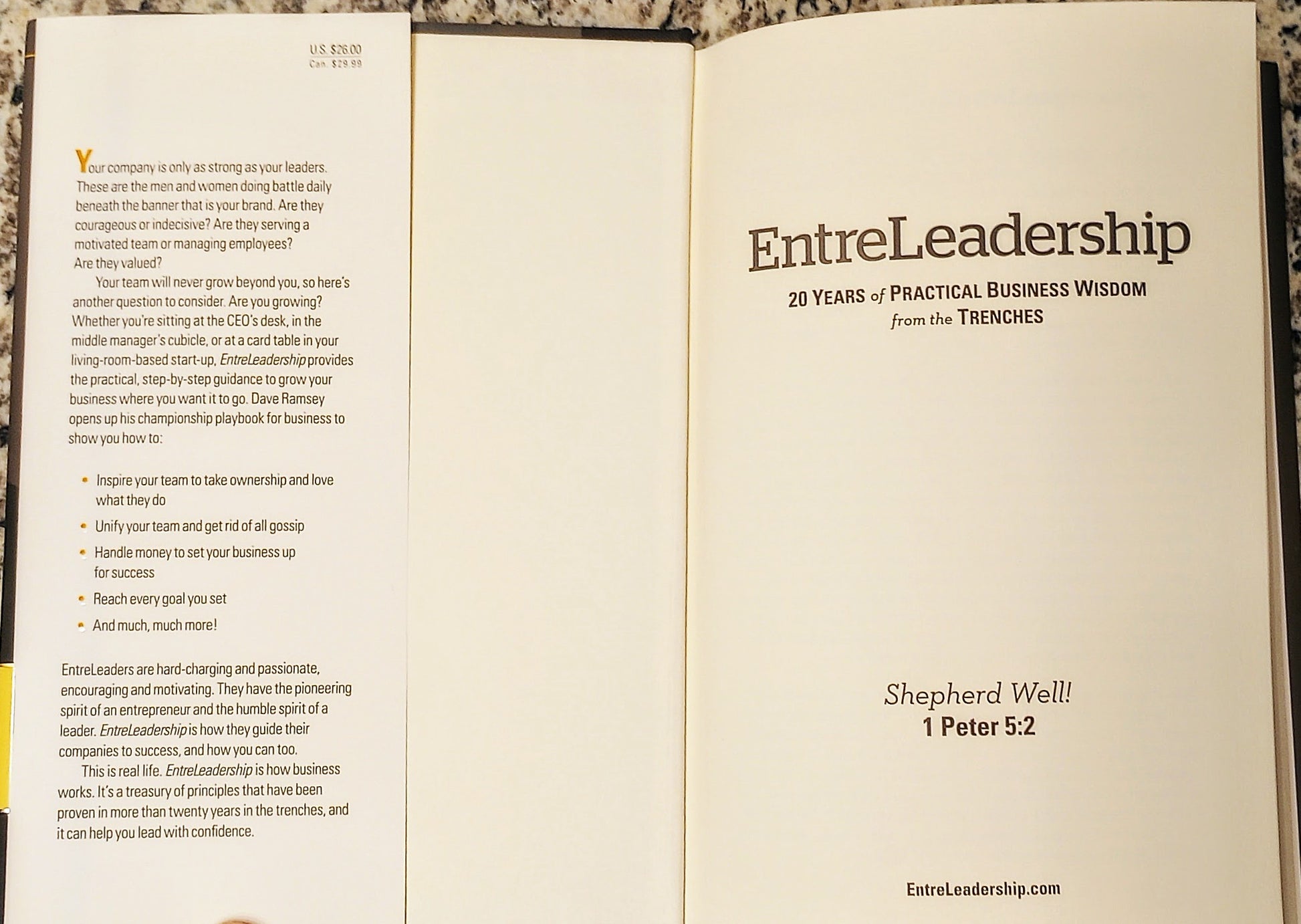 Open book with 'EntreLeadership' title and text on a wooden surface