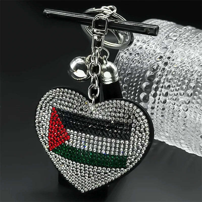 Heart-shaped rhinestone keychain with Palestinian flag design on a dark background