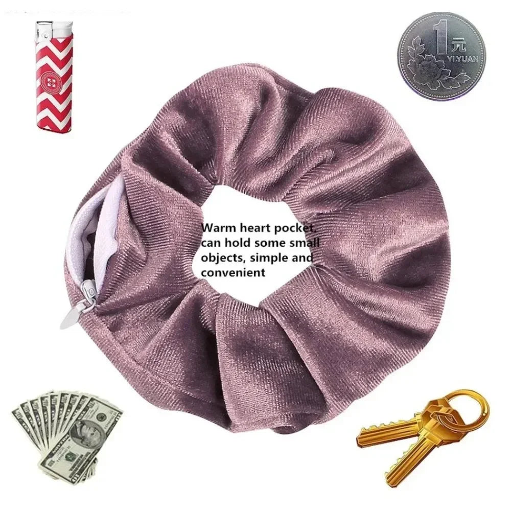 Purple scrunchie with a small pocket, keychain, money, and coin on a white background