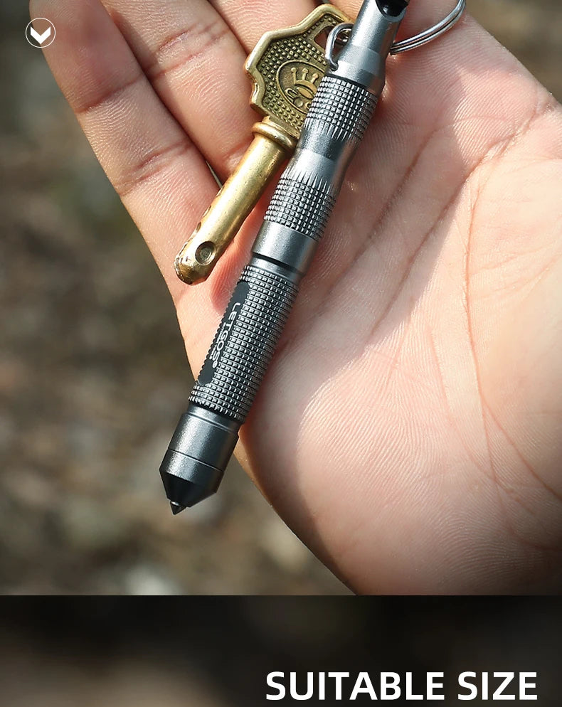 Power whistle keychain with a pen and key on a hand against a blurred natural background