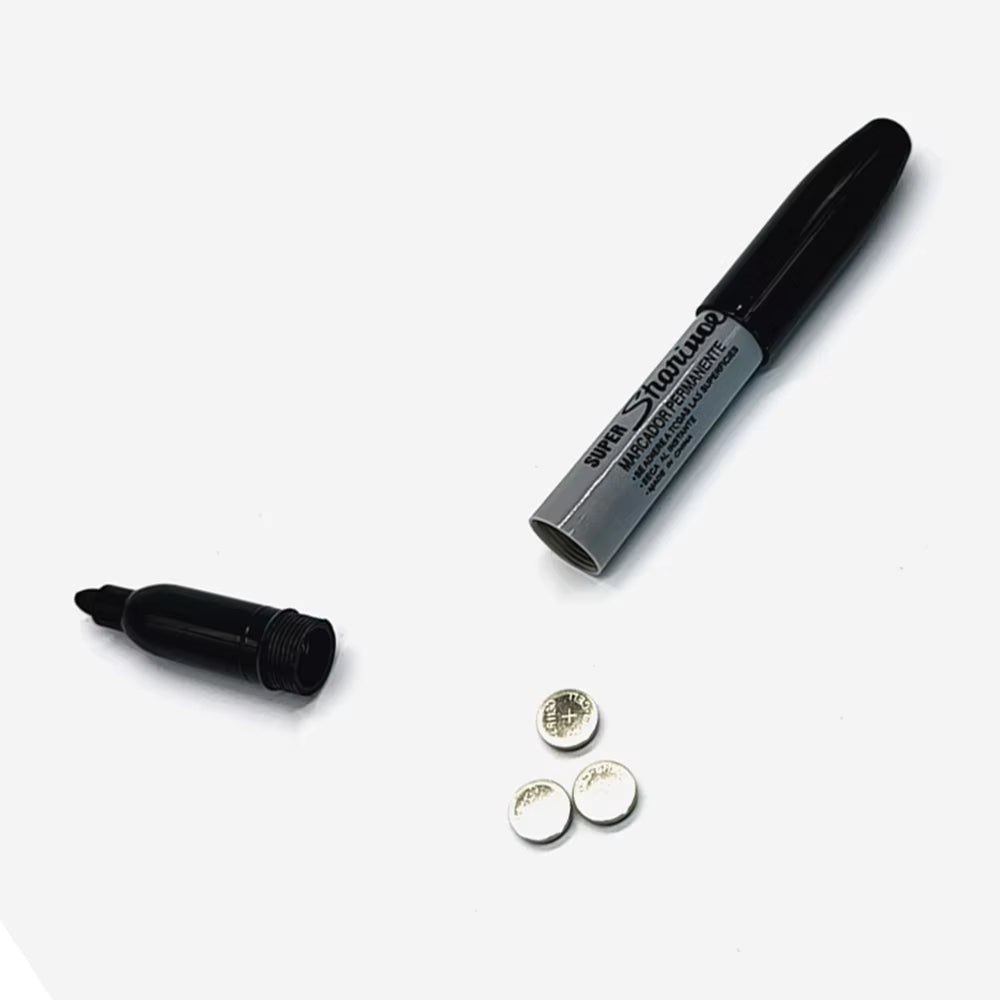 Hollowed out black permanent marker with screw off cap for storing valuables. Displayed open with cap separated from body.