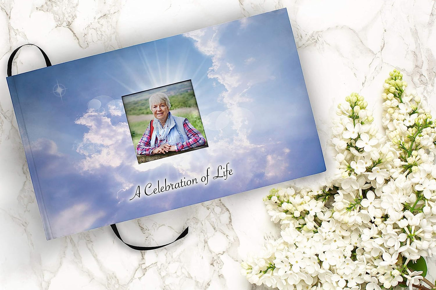 Front book cover view of 'Holy Heavens Dearly Departed Photo Funeral Guestbook Attendance Log' featuring a woman on the cover of the "Celebration of Life" funeral guest attendance guestbook.