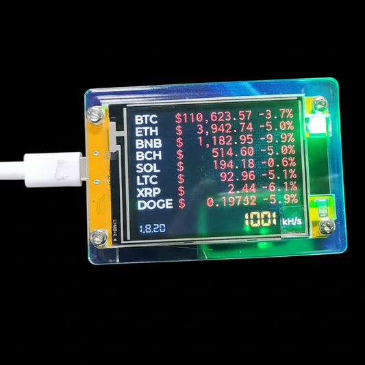 A USB-connected digital crypto miner with an LCD display showing Bitcoin and Ethereum prices and connection speed, housed in a translucent blue-green case on a black background.