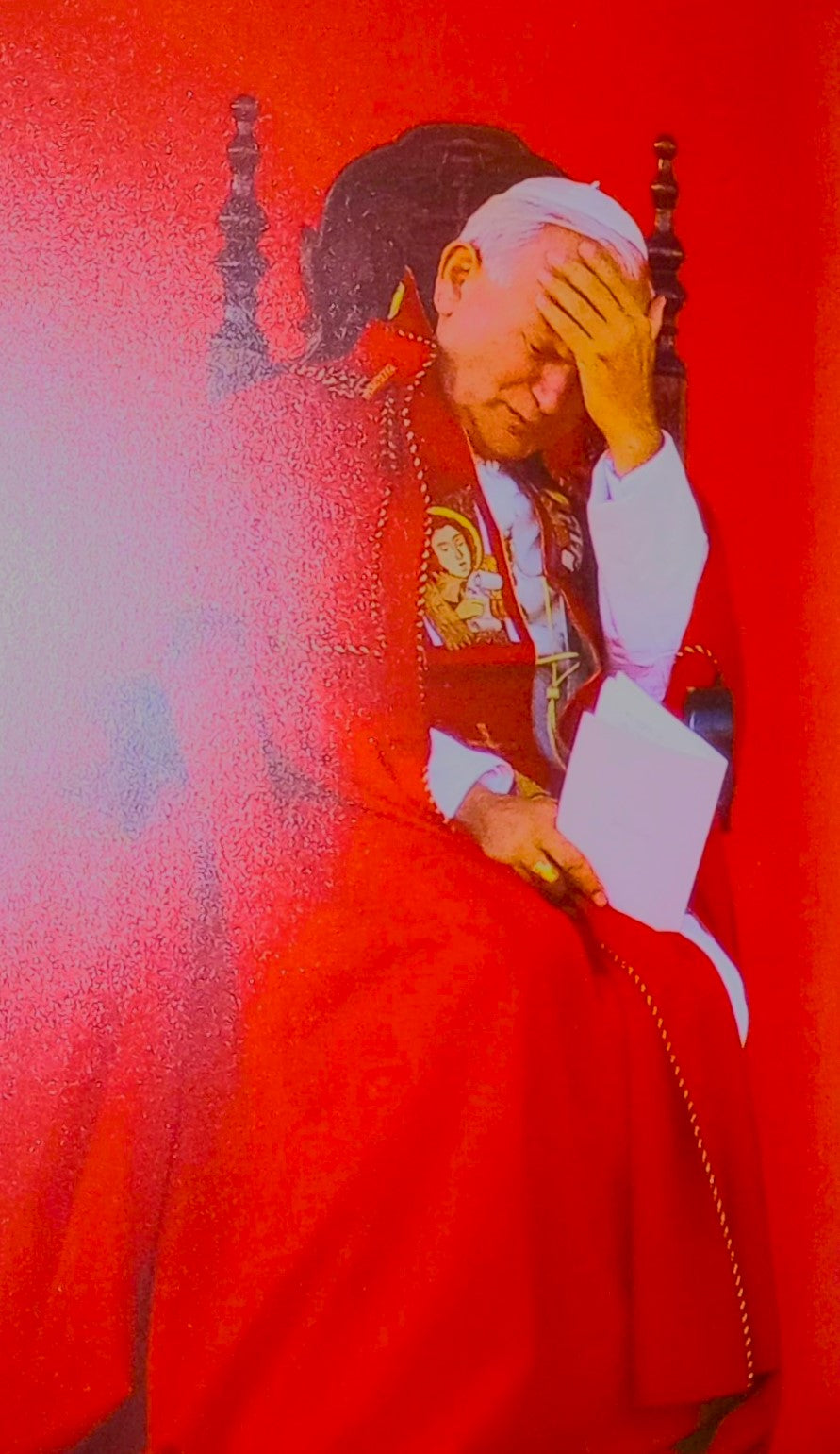 Page from the book titled 'An Invitation to Joy' by John Paul II featuring a photograph of the Pope in a red papal vestment and his hand over his head.