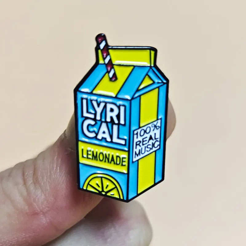 Cartoon-style lemonade box with 'LYRICAL LEMONADE' and '100% Real Music' text, held by a hand against a beige background.