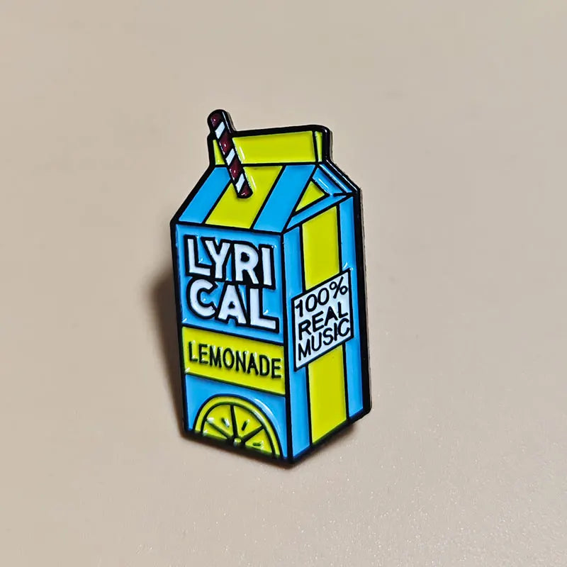 Juice WRLD enamel pin shaped like a lemonade juice box carton with 'LYRICAL LEMONADE' text on a beige background