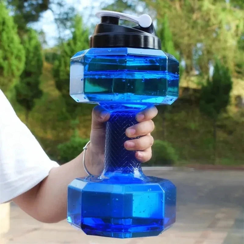 Blue dumbbell-shaped water bottle held by a person outdoors