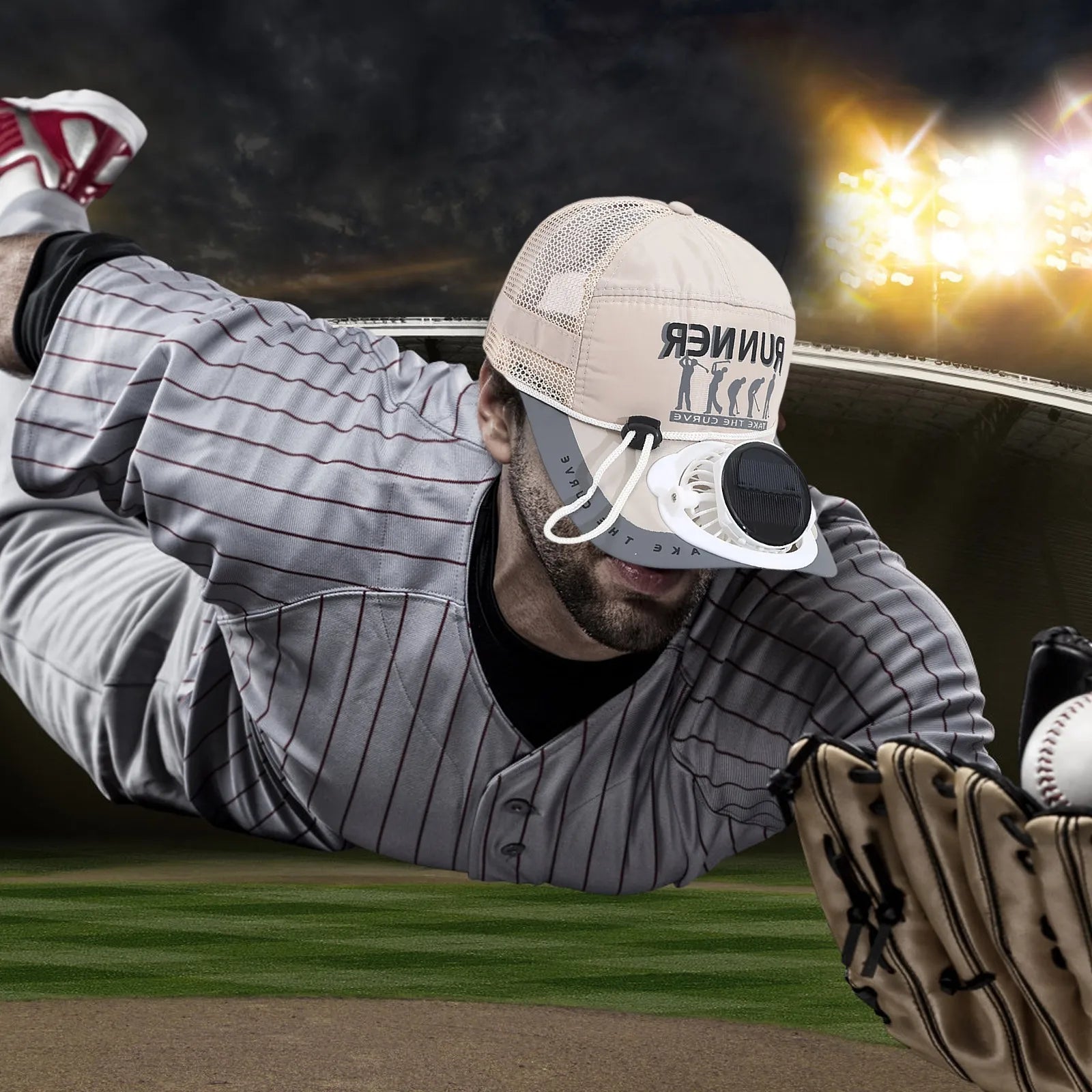 Baseball player wearing keep cool sun fan cap in action, diving for a catch, on a field with stadium lights in the background.