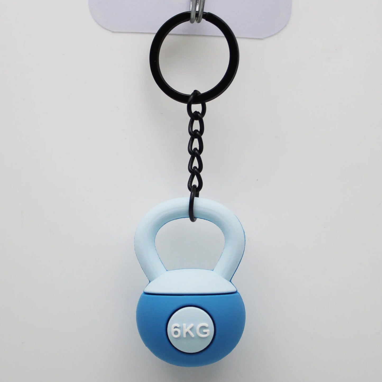 Blue kettlebell-shaped keychain with '6KG' label on a white background