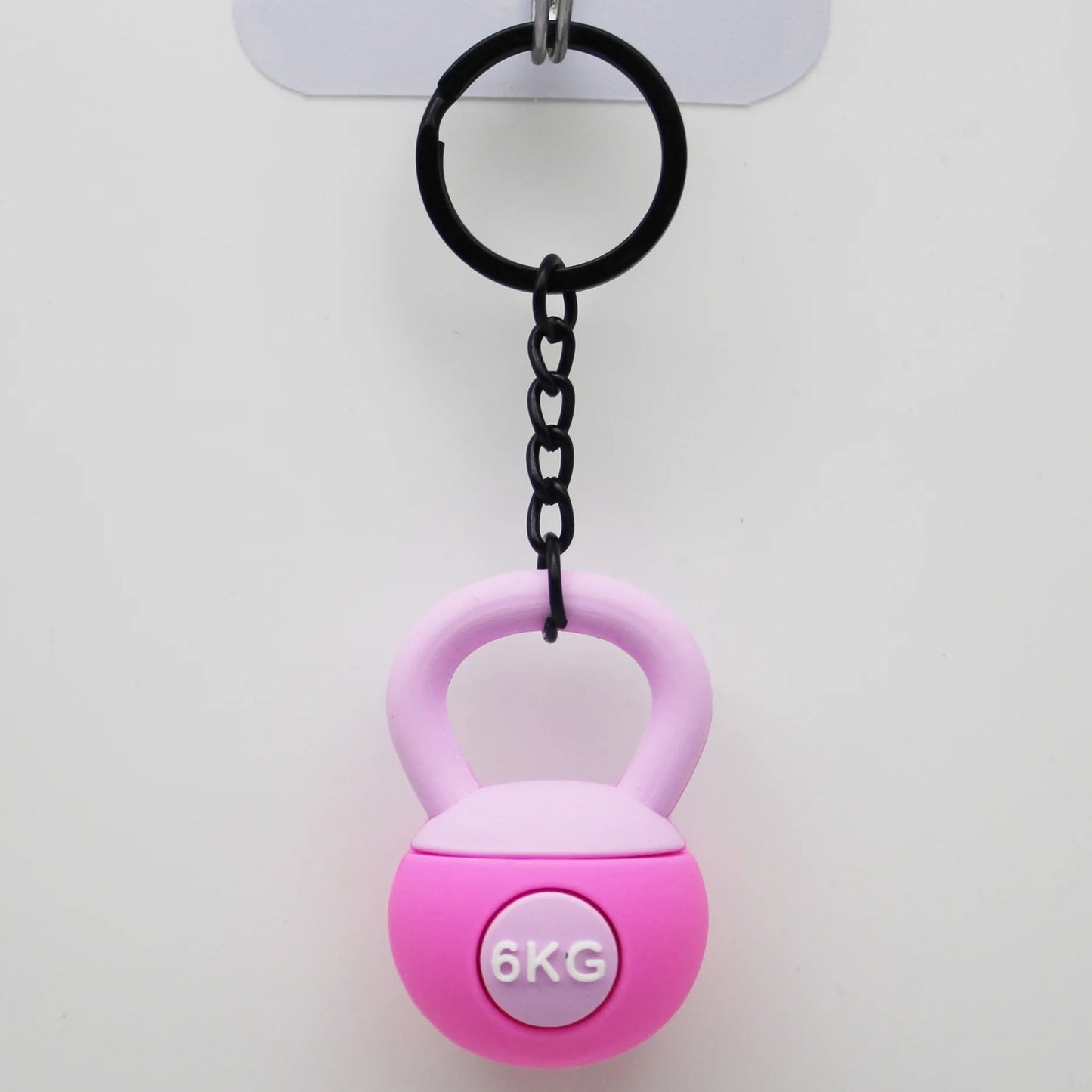 Pink kettlebell-shaped keychain with '6KG' label on a white background