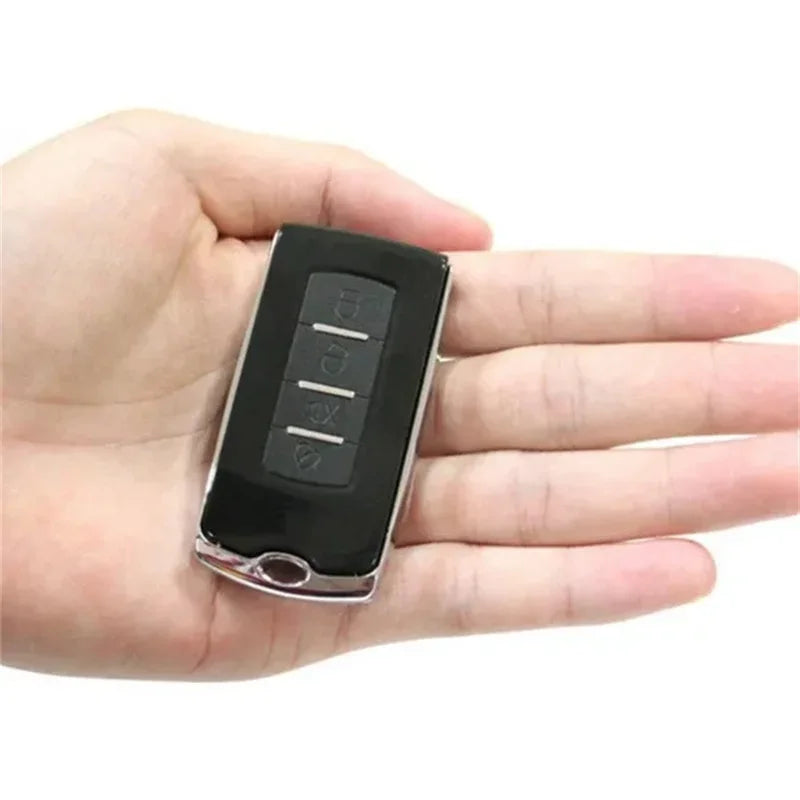 Black car key fob digital scale decoy held in a hand on a white background