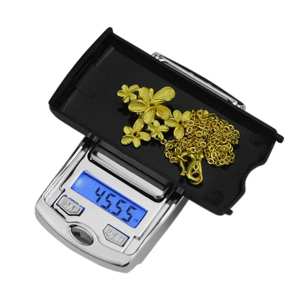 Digital scale with gold jewelry on a white background