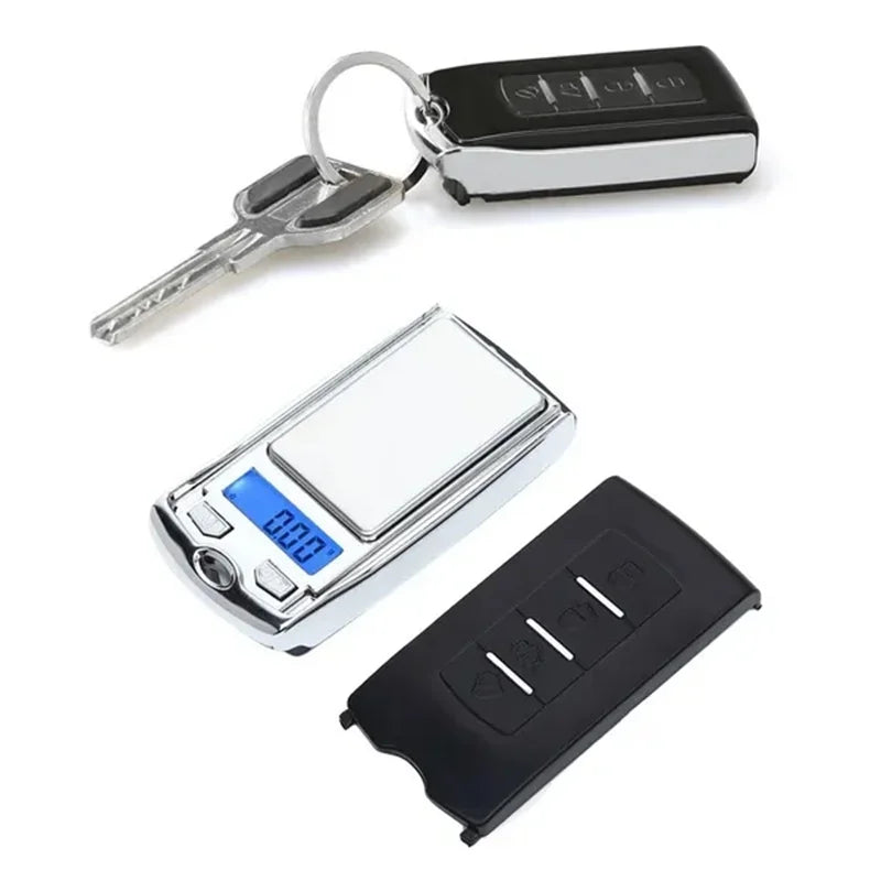 Digital pocket scale, keychain, and remote control on a white background