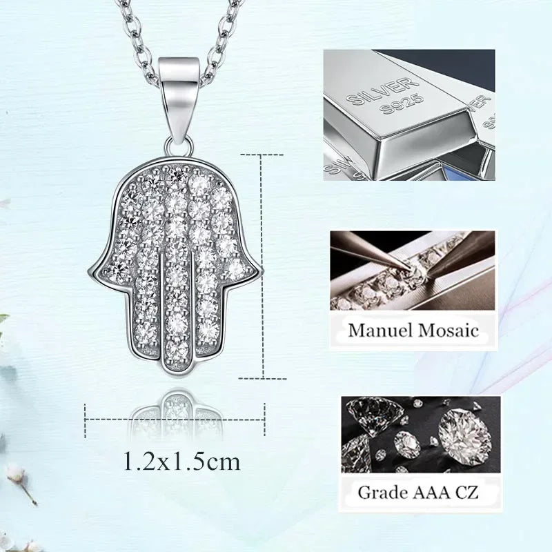 Silver Hamsa pendant with diamond details, displayed on a light blue background.