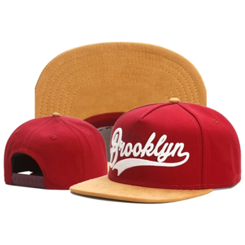 Burgundy snapback cap with 'Brooklyn' text on a white background