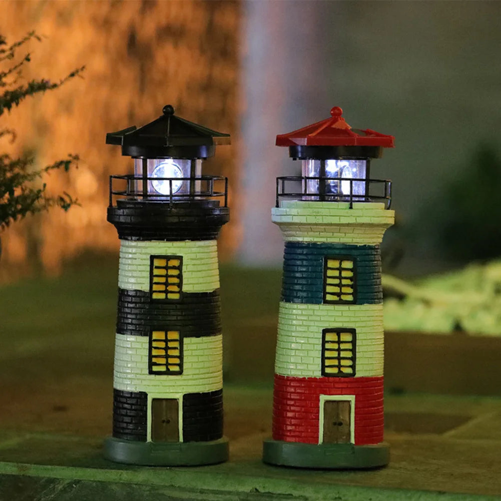 Two miniature lighthouses with illuminated lights on a blurred natural background