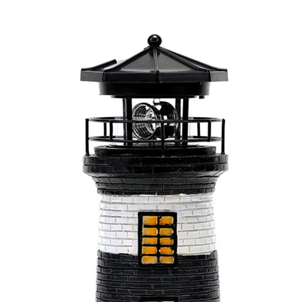 Model of a lighthouse with black and white design on a white background