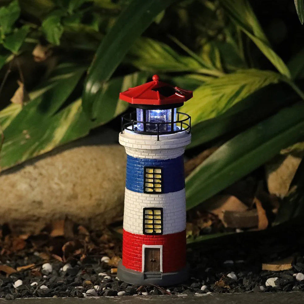 Model lighthouse with red and blue design on a natural background