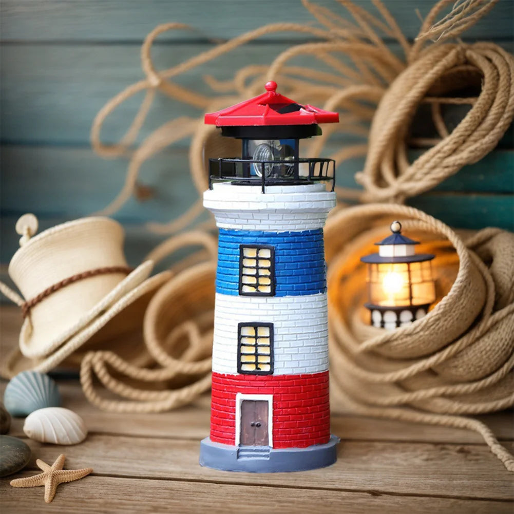 Decorative lighthouse with a red roof, white walls, and blue base on a wooden surface with nautical elements.
