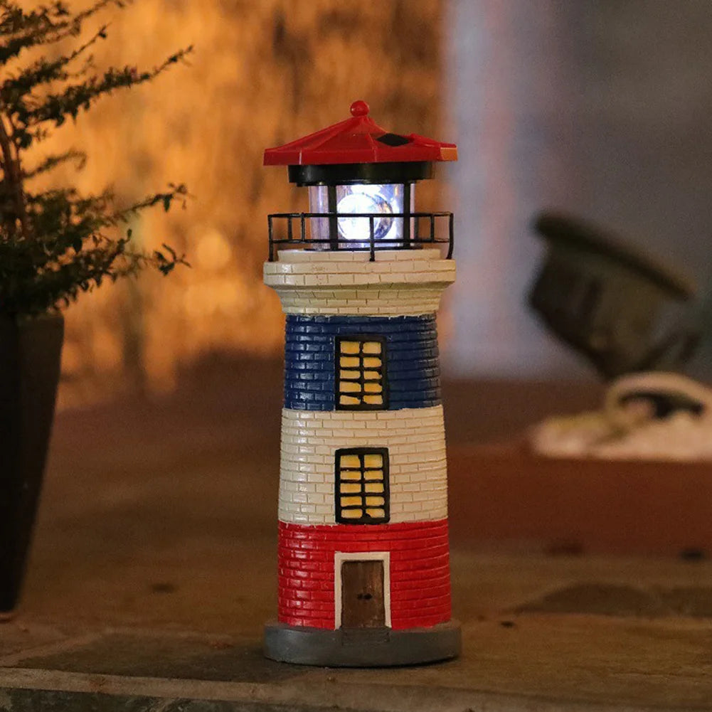 Decorative lighthouse with red, white, and blue colors on a wooden surface.