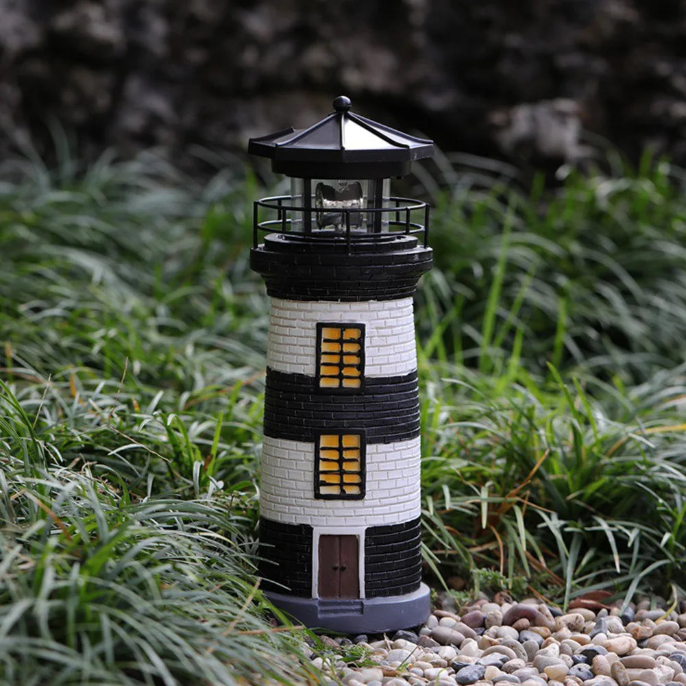 Decorative lighthouse on a grassy area with a blurred background