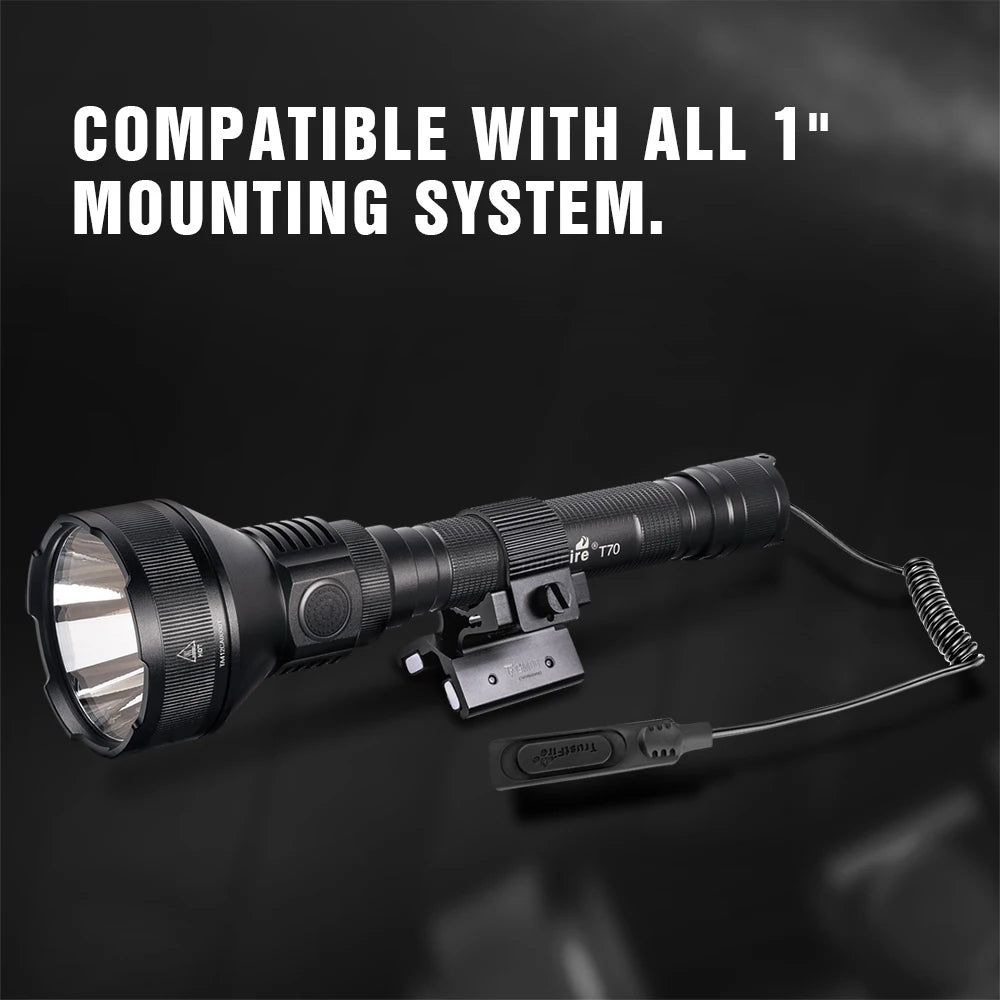 Black flashlight with mounting system on a dark background, text indicating compatibility with all 1" mounting systems.