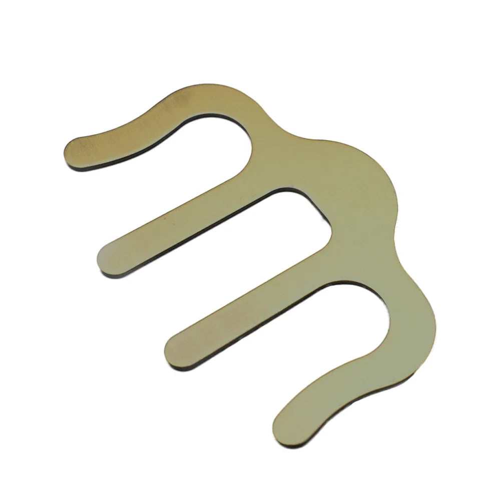 Bronze metal M-shaped page book clamp for sheet music tool on a white background